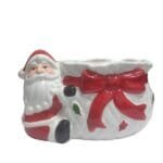 Doceira decorativa de Natal em cerâmica com Papai Noel abraçando o vaso, ideal para servir doces e decorar mesas natalinas.