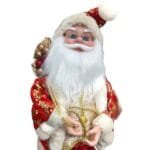 Papai Noel decorativo musical com chave de corda nas costas, movimento de cabeça e roupas detalhadas em tecido premium.