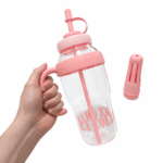 Garrafa plástica na cor rosa, com tampa, vedação de silicone, ponteira e suporte interno para mexer a bebida.