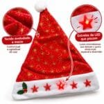 Gorro natalino vermelho confeccionado em tecido aveludado, com estampas douradas, pompom branco e estrelas de LED na faixa inferior.