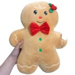 Almofada Gingerbread com indicação das medidas aproximadas de 42 cm de comprimento, 30 cm de largura e 12 cm de espessura.